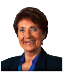 A smiling woman in a business suit attending a marketing workshop.