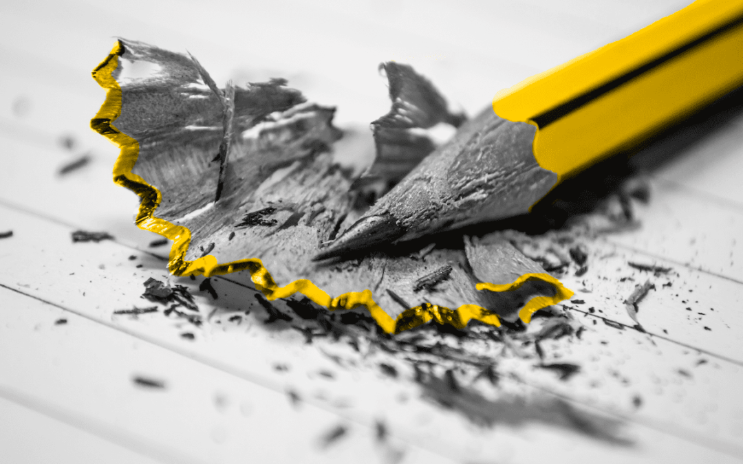 A yellow pencil with a hole in it on a piece of paper used for a small business marketing workshop.