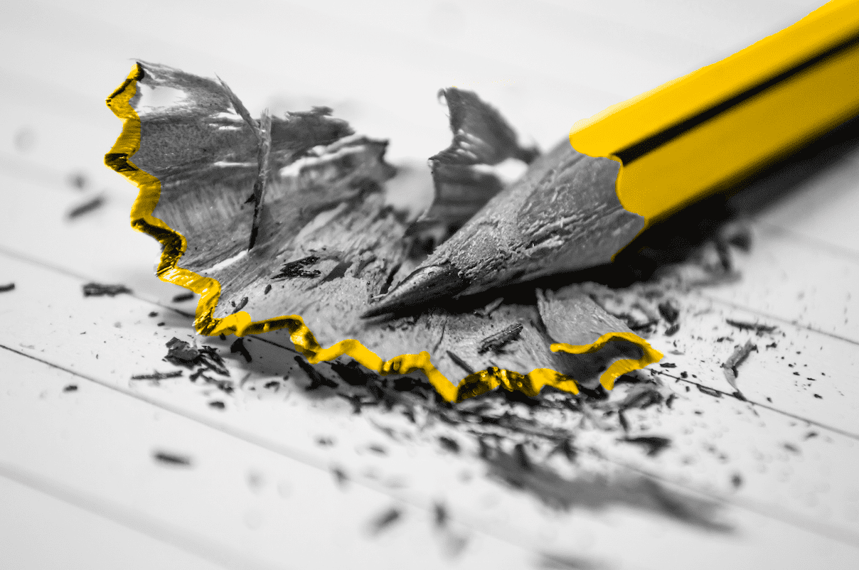 A yellow pencil with a hole in it on a piece of paper used for a small business marketing workshop.