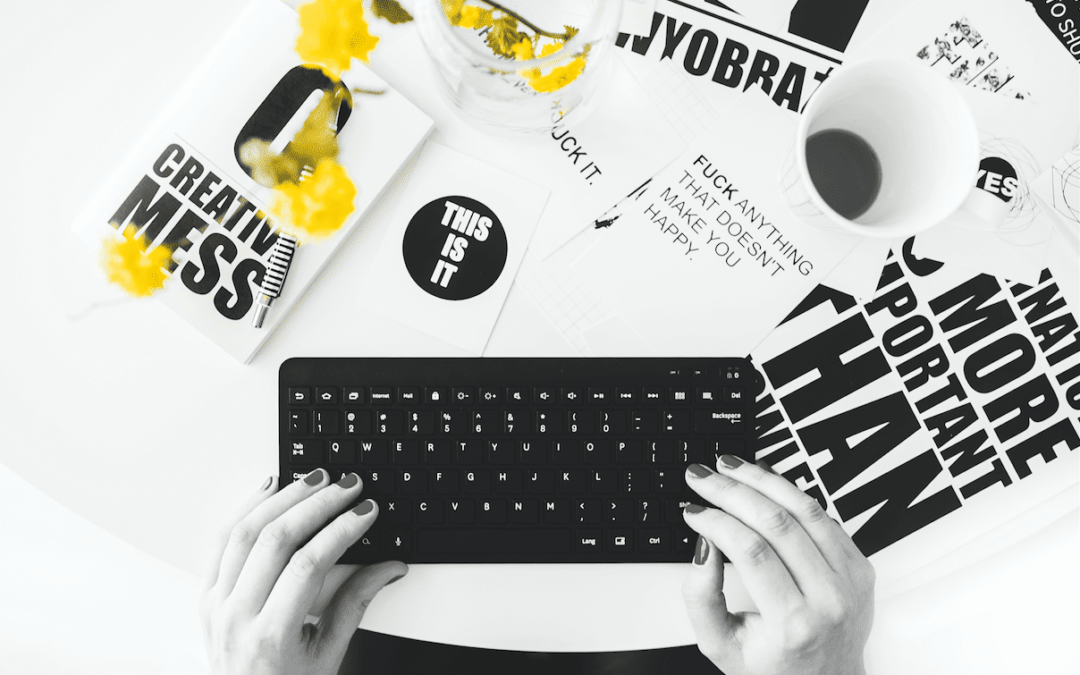 A black and white photo of a person typing on a keyboard during a marketing workshop.