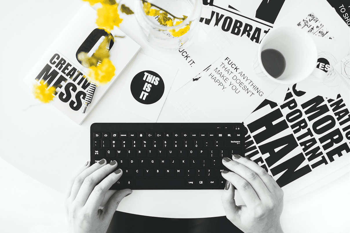 A black and white photo of a person typing on a keyboard during a marketing workshop.