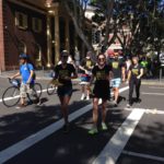 A group of small business owners crossing a street after attending a marketing workshop and receiving mentorship.