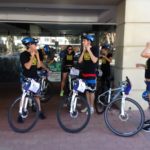 A group of people participating in a marketing workshop, standing next to bicycles.