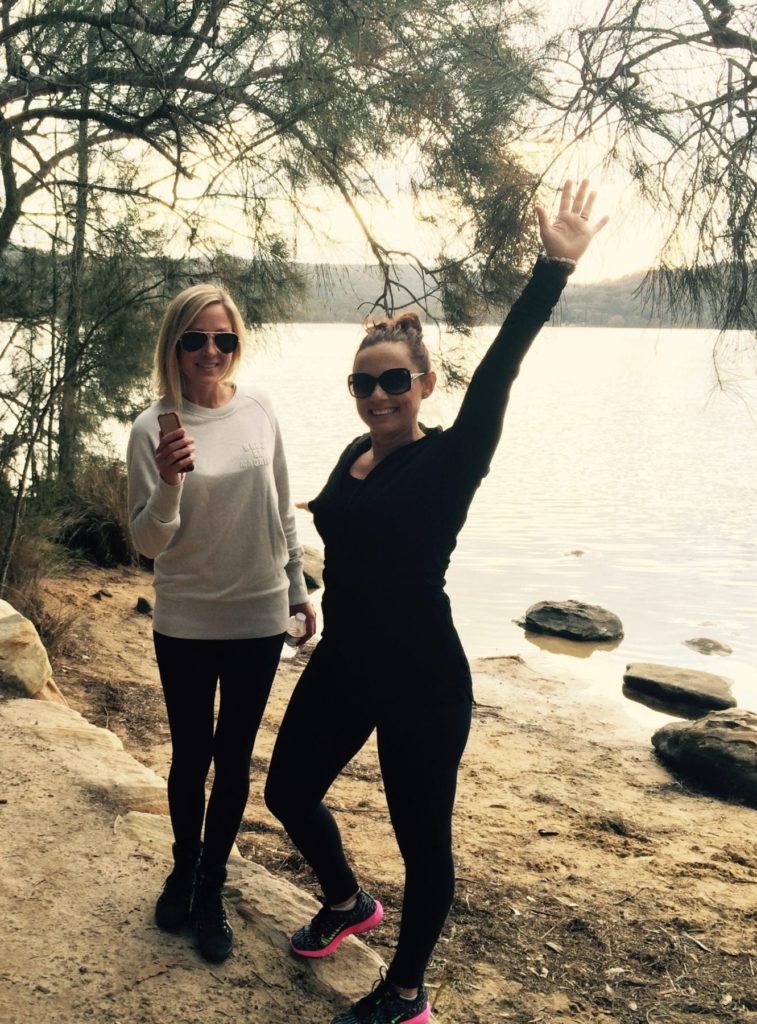 Two women hosting a marketing workshop near a body of water as part of their small business marketing plan.