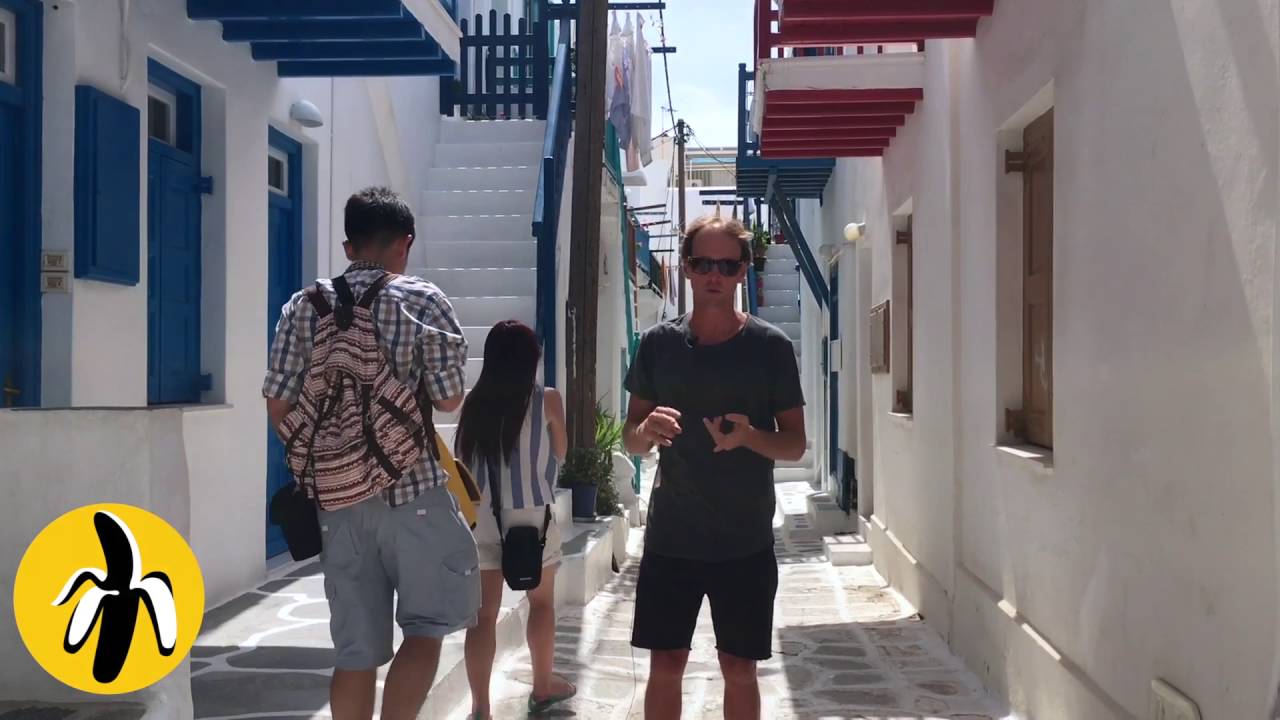 A small group of people walking down a narrow alley, engaged in a marketing workshop.