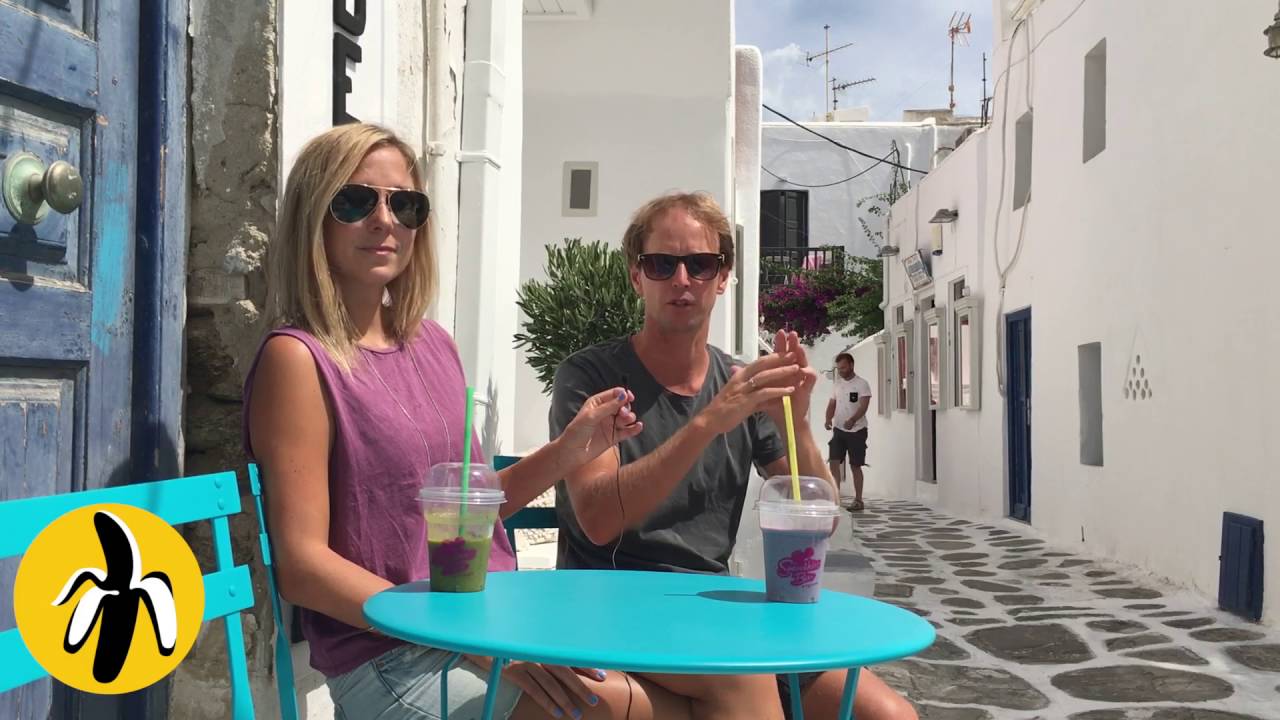 Two people participating in a small business marketing mentoring session at a table in a narrow alley.