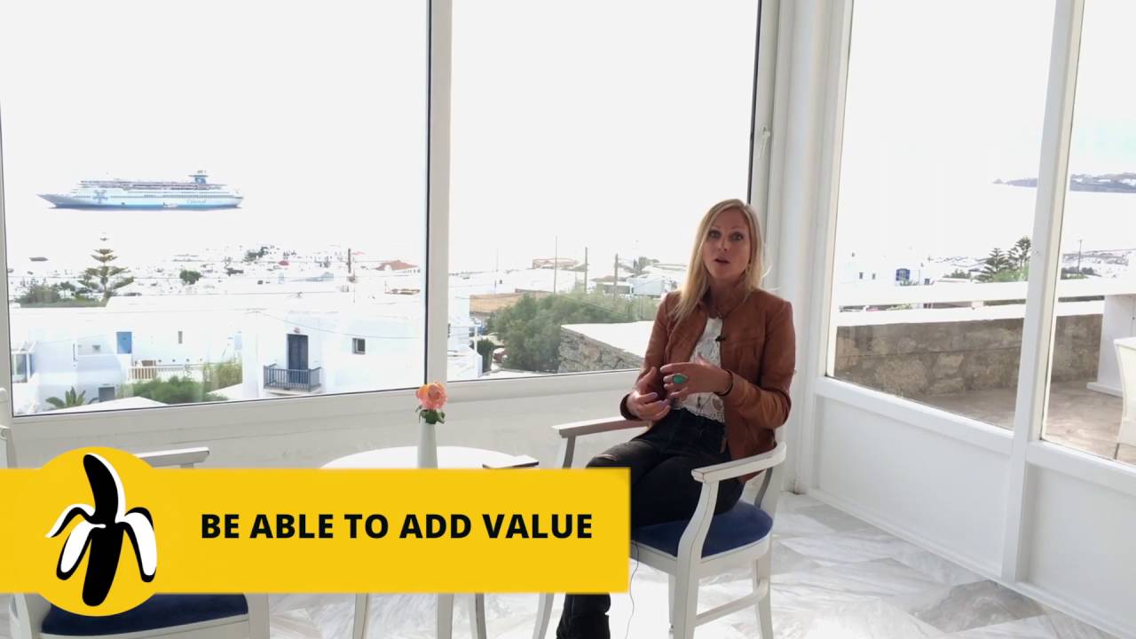 A woman sitting in front of a window, passionately engaging in a marketing workshop.