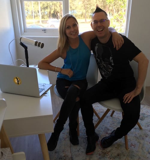 A man and woman attending a marketing workshop, sitting in front of a desk with a laptop.