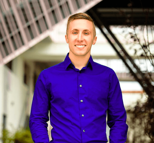 The man is attending a marketing workshop while wearing a blue shirt.