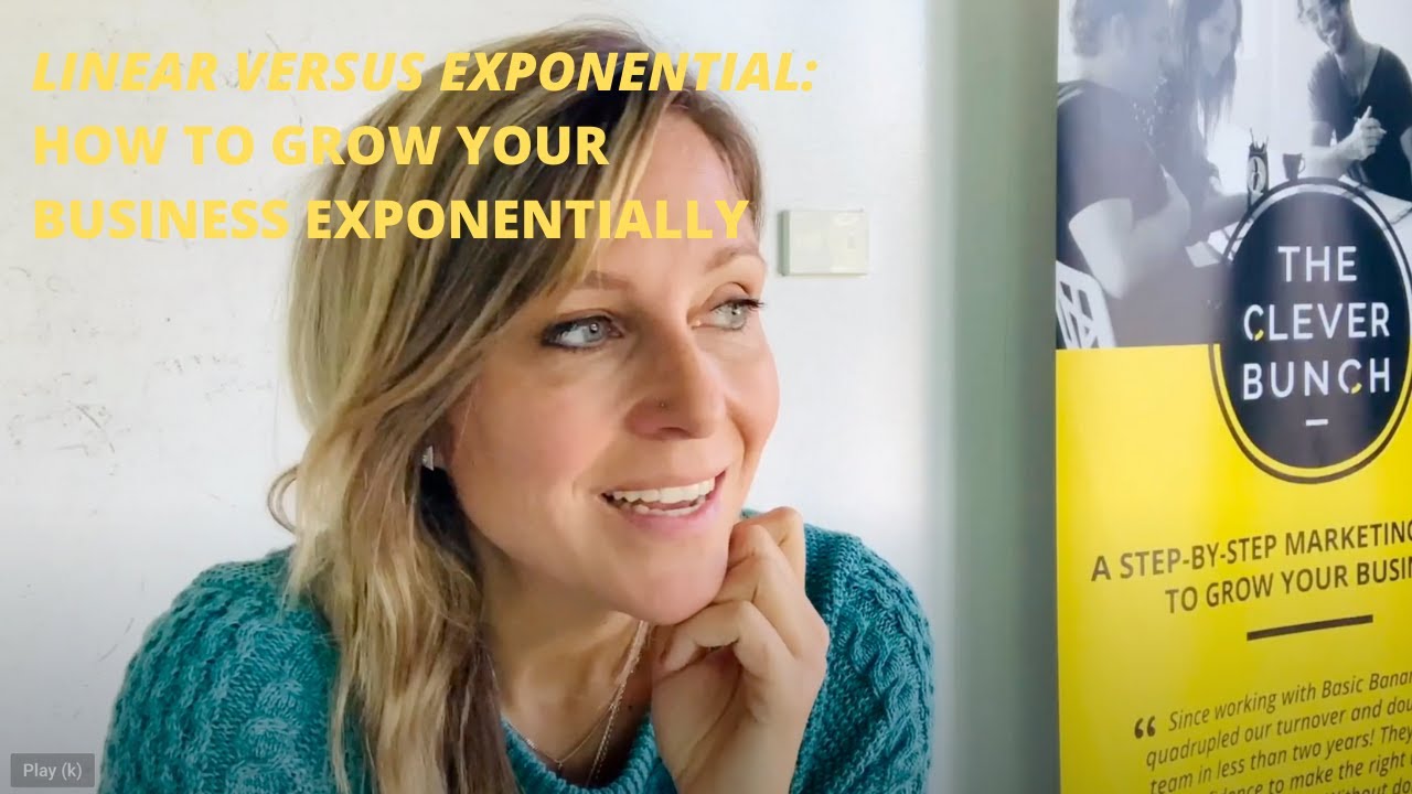 A woman is standing in front of a sign with the words "Lincoln versus Exponential" as she attends a marketing workshop to learn how to grow her small business exponentially.