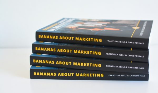 A stack of books with the title "Bananas About Marketing" - a small business marketing guide.
