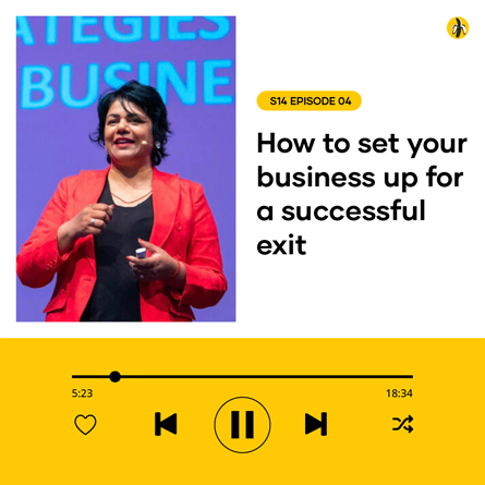 A woman in a red jacket presenting at a business event with a title about setting up a business for a successful exit.