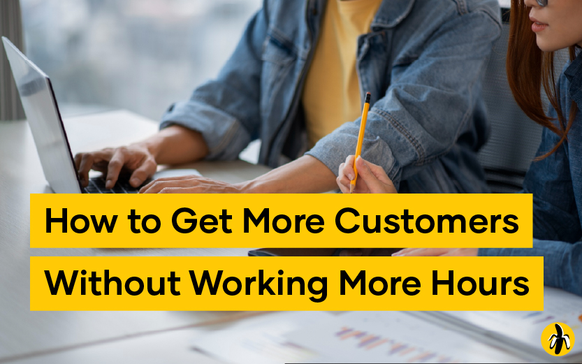 People collaborating at a desk with a laptop; bold yellow banner reads 'How to Get More Customers Without Working More Hours'